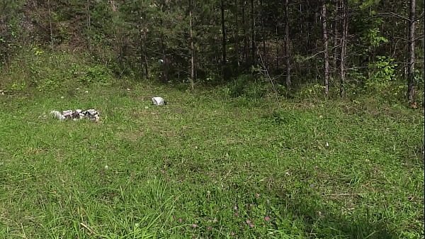 Voyeur with a hidden camera spies on a blonde with a gorgeous ass who is sunbathing in a clearing, takes off her panties and fingering her hairy cunt in nature.